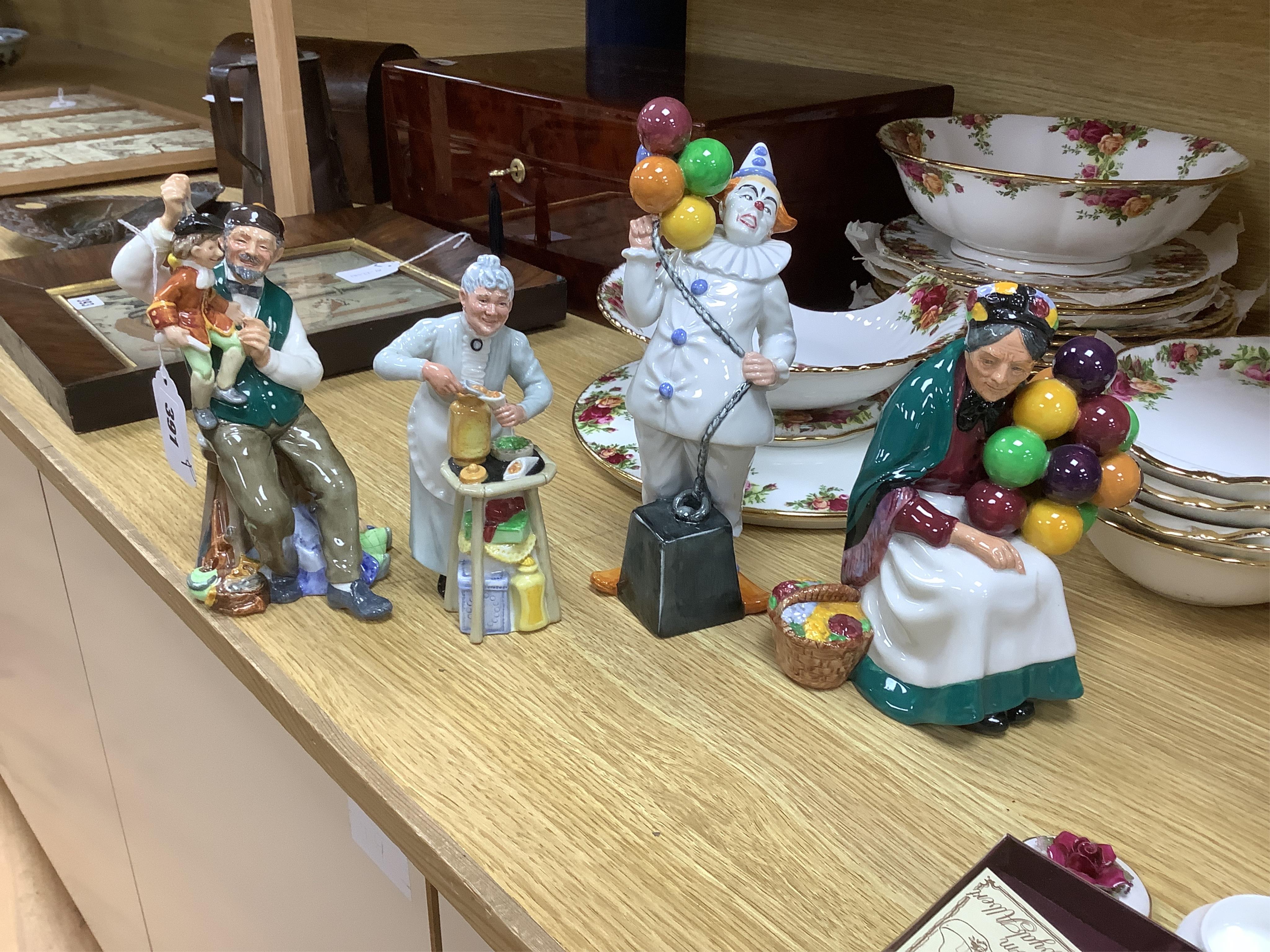 A collection of Royal Doulton figures to include The Old Balloon Seller, Doctor, Votes for Women and The Detective